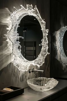 a bathroom sink sitting under a round mirror next to a wall mounted faucet