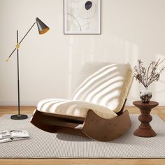 a living room scene with focus on the chaise lounge chair and side table in the foreground