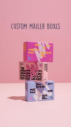 three boxes stacked on top of each other in front of a pink wall and floor