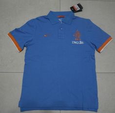 a blue polo shirt with an orange and white stripe on the left side, sitting on a tile floor