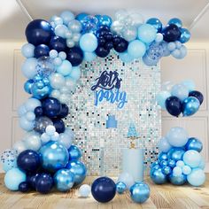 a blue and white birthday party with balloons