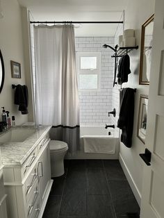 a bathroom with black and white tile flooring