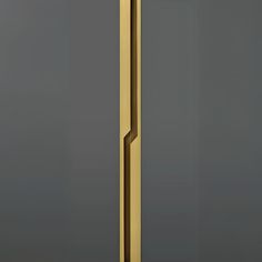 a golden door handle on a gray wall