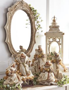 a group of figurines sitting on top of a table next to a mirror