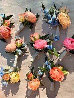 several different colored flowers are arranged on a table