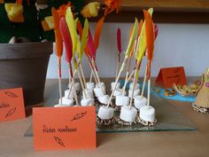 there are many small marshmallows with arrows on them and some orange cards