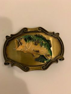 WELCOME TO RAMBRANDTOOLS DESCRIPTION: Offering a Vintage 1978 Paintree Bass Fish Belt Buckle Made in the USA 1978 Very heavy 2d cast Brass Measure 3-1/2'' across x 2-1/2'' high. Will Accommodate belt straps up to 1-11/16'' wide. See pictures for more details and condition. CONDITION: The soft warm original finish is present with no buffing or machine polishing. The excellent original condition and clear detail, with no removal, repairs or alterations make this an especially attractive offering. Fish Belt, Belt Buckles Men's, Bass Fish, Palm Coast, Vintage Belt Buckles, Craft Night, Bass Fishing, Secret Santa, Belt Buckle