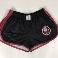 the shorts are black with red trims and an embroidered tiger on the side, along with a white background