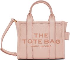 Grained leather tote in pink. Logo embossed at face. · Twin rolled carry handles at top · Detachable and adjustable shoulder strap · Carry handle at side · Logo patch at back face · Zip closure · Leather lining · Logo-engraved gold-tone hardware · H6 x W7 x D4 in Supplier color: Rose Marc Jacobs Tote, Small Tote Bag, Pink Tote, Crossbody Tote Bag, Mini Tote Bag, Marc Jacobs Bag, The Tote Bag, Medium Tote, Small Tote