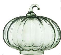 a glass pumpkin shaped object on a white background