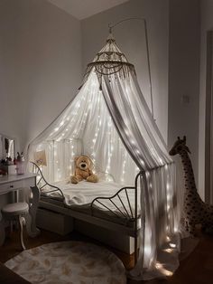 a teddy bear sitting on top of a bed in a room filled with furniture and lights