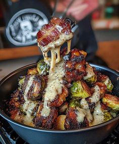 a pan filled with cooked brussel sprouts and bacon covered in gravy