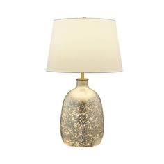 a table lamp with a white shade on it's base and a gold finish