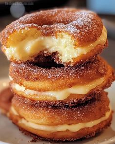 three donuts stacked on top of each other with icing and powdered sugar