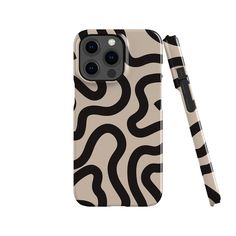 an iphone case with a black and white zebra print on the back, next to a pen