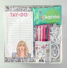 a gift box containing a notepad, pencils, coffee mug and personalized items