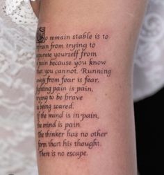 a woman's arm with a poem written on it