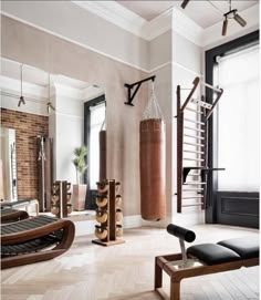 a living room filled with furniture and a punching bag