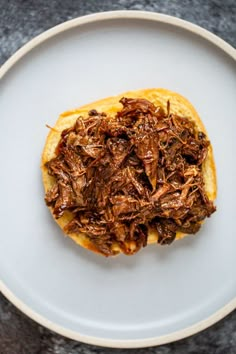 a white plate topped with food on top of a table