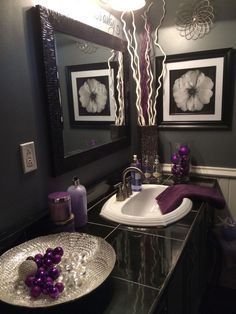 a bathroom with two sinks and pictures on the wall