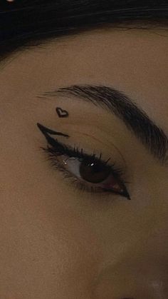 a woman with black eyeliners and long lashes