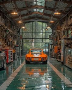 an orange sports car parked in a garage with lots of work on the walls and ceiling