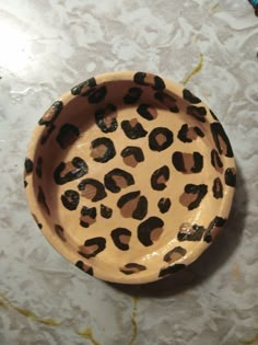 a leopard print bowl sitting on top of a table