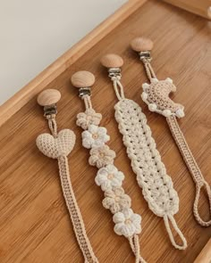 four crocheted hair clips on a wooden surface