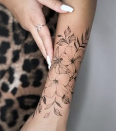 a woman's arm with flowers on it