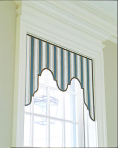 a window with a blue and white striped valance hanging from it's side