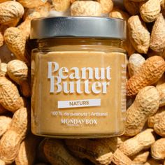 peanut butter in a jar surrounded by peanuts