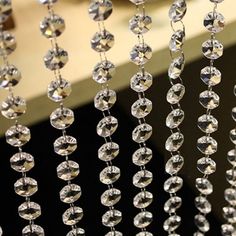 some crystal beads hanging from the side of a window