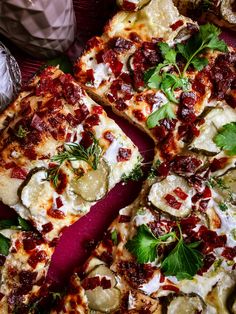 a pizza topped with lots of toppings on top of a table