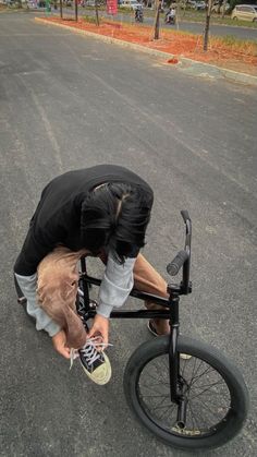 a man is bending over on his bike