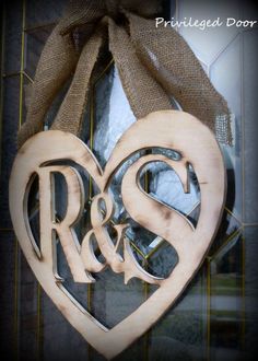 a wooden heart with the initials r and s hanging from it's front door