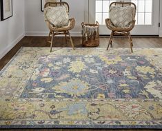 two chairs sitting on top of a rug in a room