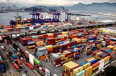 a large amount of containers are stacked on top of each other in the port area