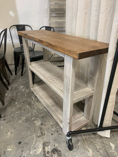 a wooden table sitting on top of a hard wood floor