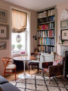 a living room filled with furniture and bookshelves