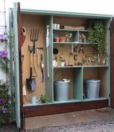 an outdoor garden storage unit with gardening tools