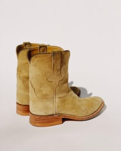 PREORDER - Ships Mid May - Early June. We think this is the PERFECT BOOT. A roper style cowboy boot made with 100% calf skin rough out suede in a tan neutral shade that goes with everything. The natural color reminds me of my grandfather's work gloves he used to use on his ranch. Natural welt, 6" shaft, 1 1/4" heel with a rubber cap, roper heel and roper toe, B width. These puppies are super comfortable. Wear them with all of our overalls, pants, jeans, and dresses. The Ranch Boot is custom hand Mens Western Boots, Classic Brown Boots For Ranch, Brown Suede Boots For Ranch, Rustic Snip Toe Ranch Boots, Luxury Suede Cowboy Boots For Ranch, Classic Snip Toe Ranch Boots, Mens Roper Boots, Roper Boots