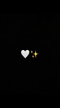 two white hearts with gold stars in the dark