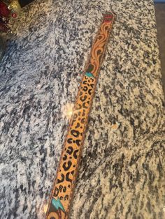 an animal print tie sitting on top of a counter next to a christmas ornament