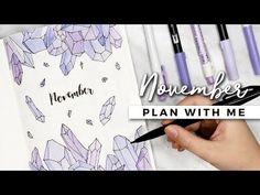 a person holding a pen and writing on a notebook with the words november plan with me