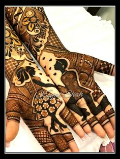 two hands with henna designs on them