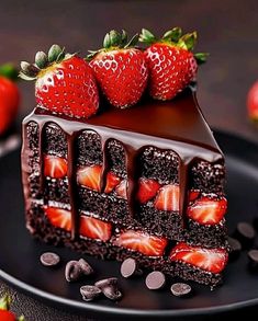 a piece of chocolate cake with strawberries on top and chocolate sauce drizzled over it