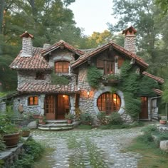 an old stone house with ivy growing on it