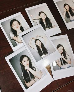 several polaroid photos of young women with long hair are arranged on a wooden table