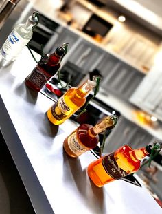 several bottles of alcohol lined up on a counter