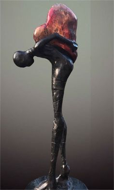 a black statue with a red hat on it's head and hands in the air